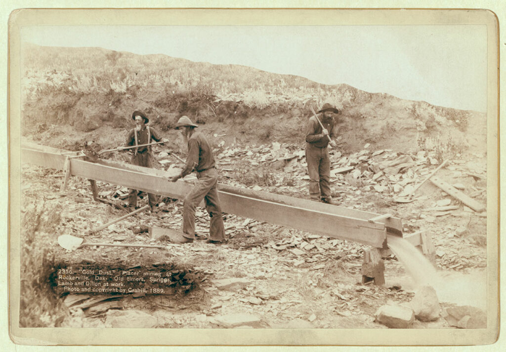 Old Timers Feed a Sluice Box while mining for gold - finding placer gold deposits